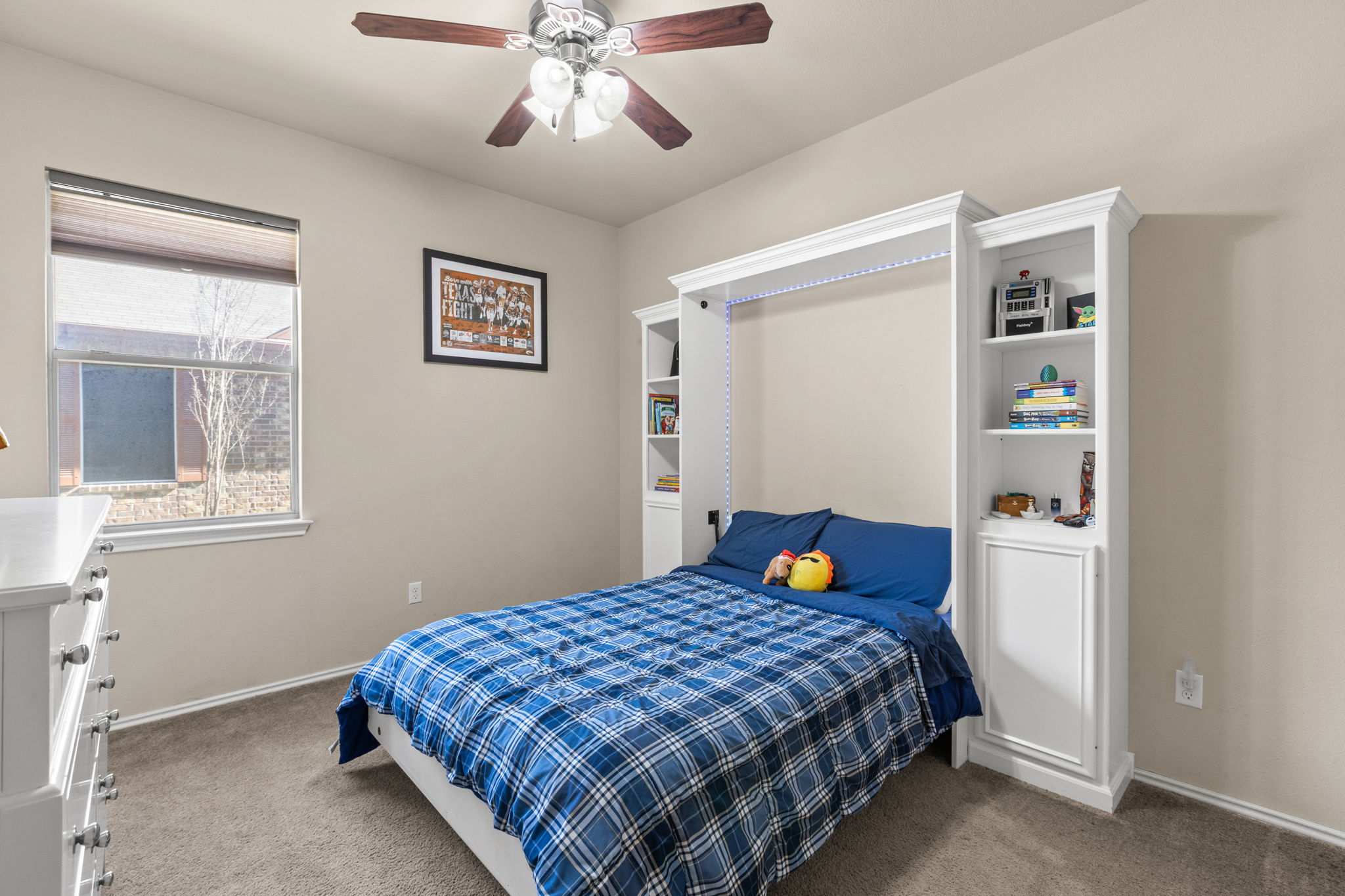 221 Blossom Valley Streme Buda, TX 78610 - Photo 33 of 40 a bedroom with a bed and a window