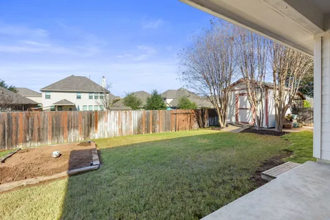 a view of a house with a yard patio and fire pit
