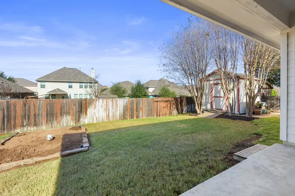a view of a house with a yard patio and fire pit
