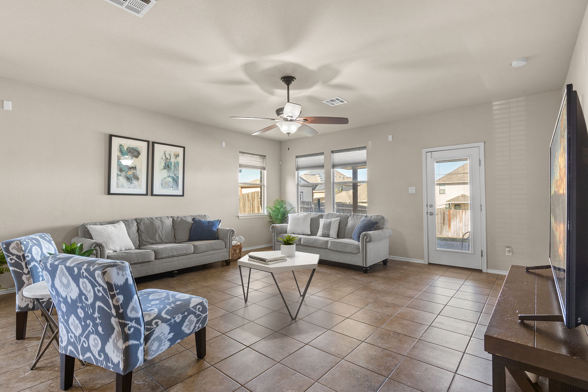221 Blossom Valley Streme Buda, TX 78610 - Photo 8 of 40 a living room with furniture and a chandelier
