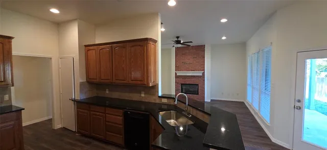 a kitchen with sink a refrigerator and cabinets