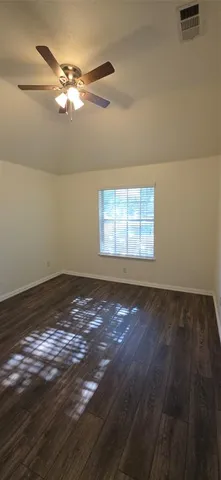 a view of a room with window and ceiling fan