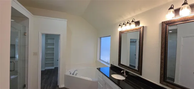 a bathroom with a tub and a shower