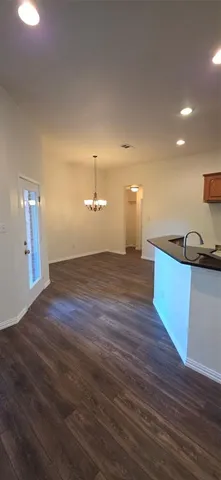 a view of a room with a sink and wooden floor