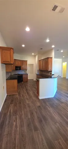 a view of kitchen with kitchen island microwave and stove