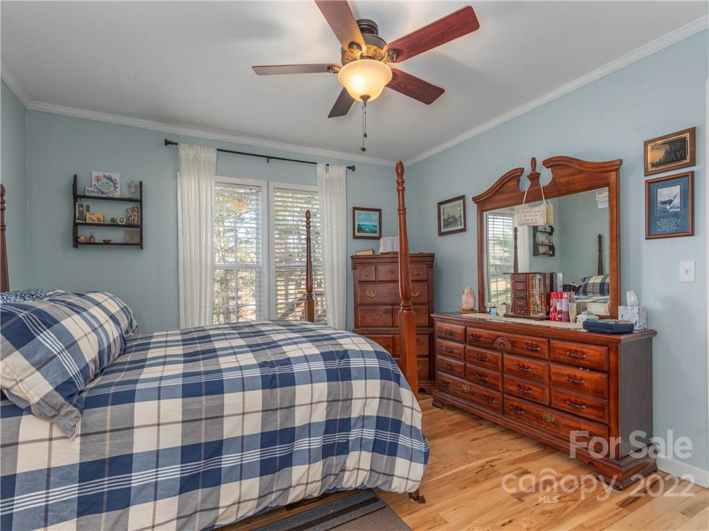 6232 Panther Creek Road Clyde, NC 28721 - Photo 11 of 25 a bedroom with a bed and a chandelier
