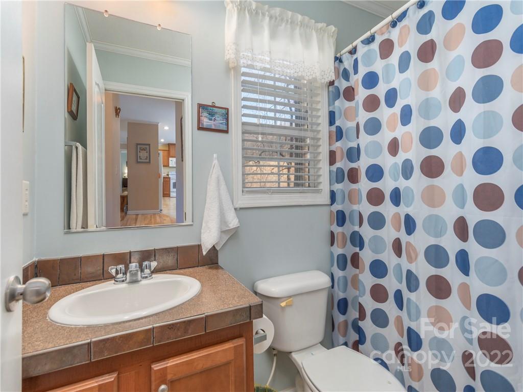 6232 Panther Creek Road Clyde, NC 28721 - Photo 14 of 25 a bathroom with a sink and a mirror