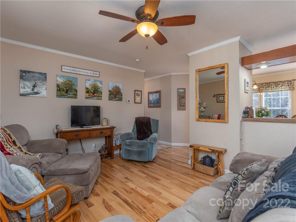6232 Panther Creek Road Clyde, NC 28721 - Photo 4 of 25 a living room with furniture and a chandelier
