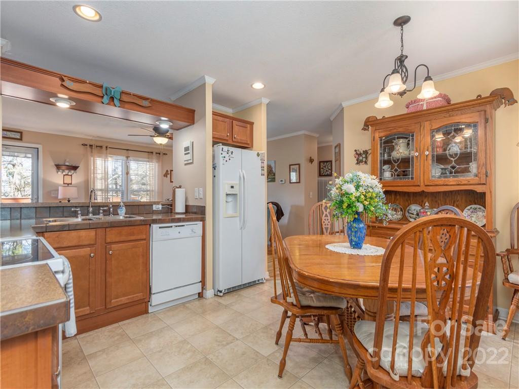 6232 Panther Creek Road Clyde, NC 28721 - Photo 8 of 25 a kitchen with stainless steel appliances granite countertop a dining table chairs and granite counter tops