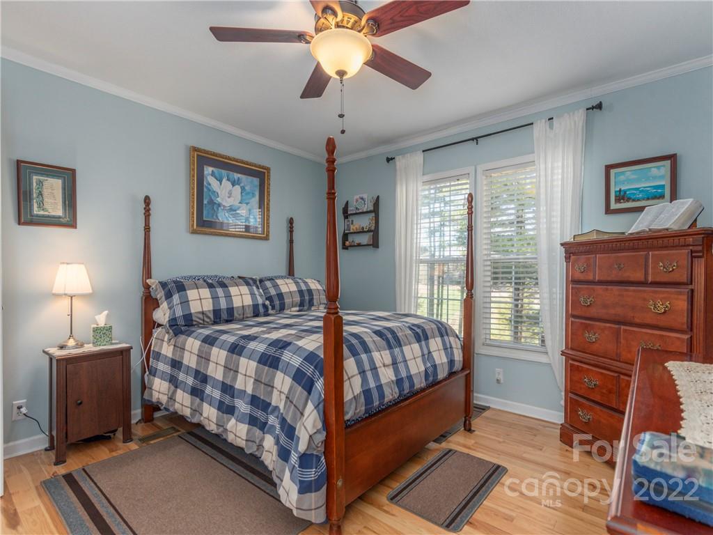 6232 Panther Creek Road Clyde, NC 28721 - Photo 10 of 25 a bedroom with a bed and wooden floor