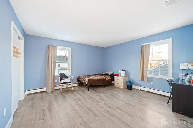a bedroom with furniture and a window