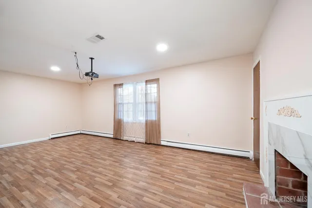 wooden floor in an empty room with a window
