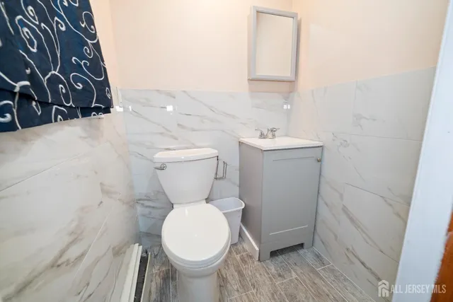 a white toilet sitting next to a bathroom sink