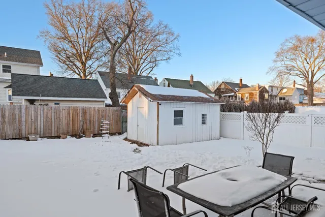 a white house with a tree in front of it