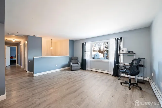 a view of a workspace with furniture and a window