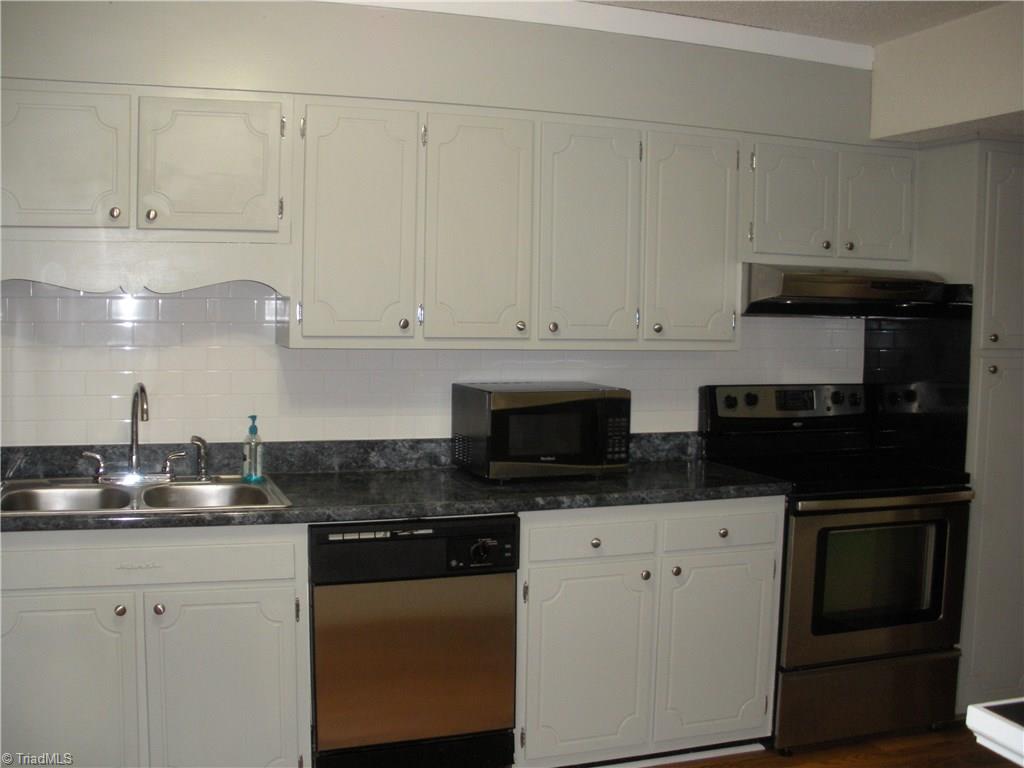 211 Northpoint Avenue, Unit G High Point, NC 27262 - Photo 7 of 21 Kitchen with stainless appliances and subway tile backsplash.