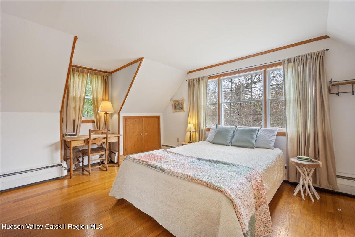 32 West Hurley Road, Unit ROUTE 375 Woodstock, NY 12498 - Photo 16 of 36 a bedroom with a bed and wooden floor