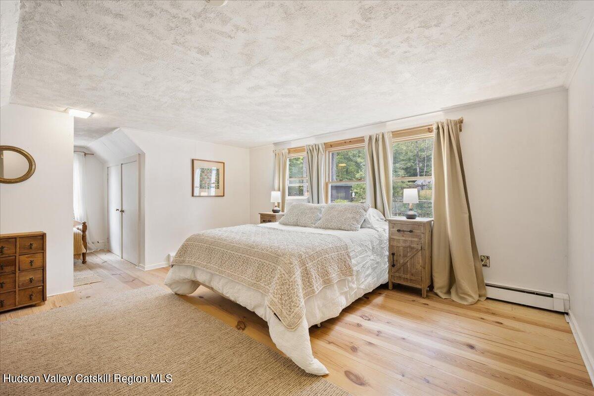 32 West Hurley Road, Unit ROUTE 375 Woodstock, NY 12498 - Photo 18 of 36 a bedroom with a bed and a large window