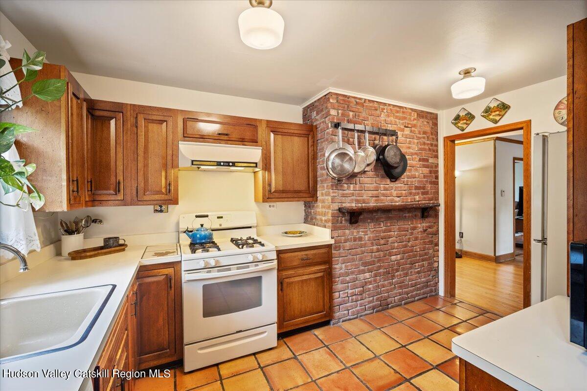 32 West Hurley Road, Unit ROUTE 375 Woodstock, NY 12498 - Photo 9 of 36 a kitchen with stainless steel appliances a stove a sink and a refrigerator