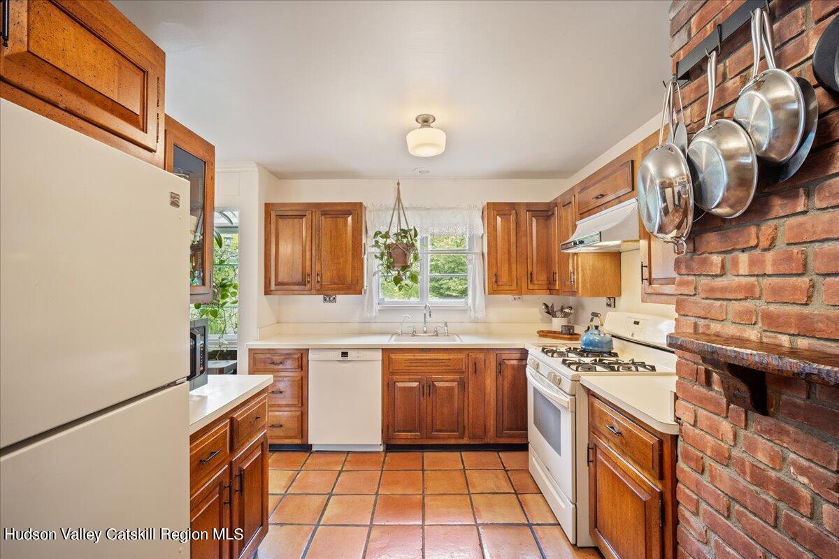32 West Hurley Road, Unit ROUTE 375 Woodstock, NY 12498 - Photo 10 of 36 a kitchen with a sink cabinets and window