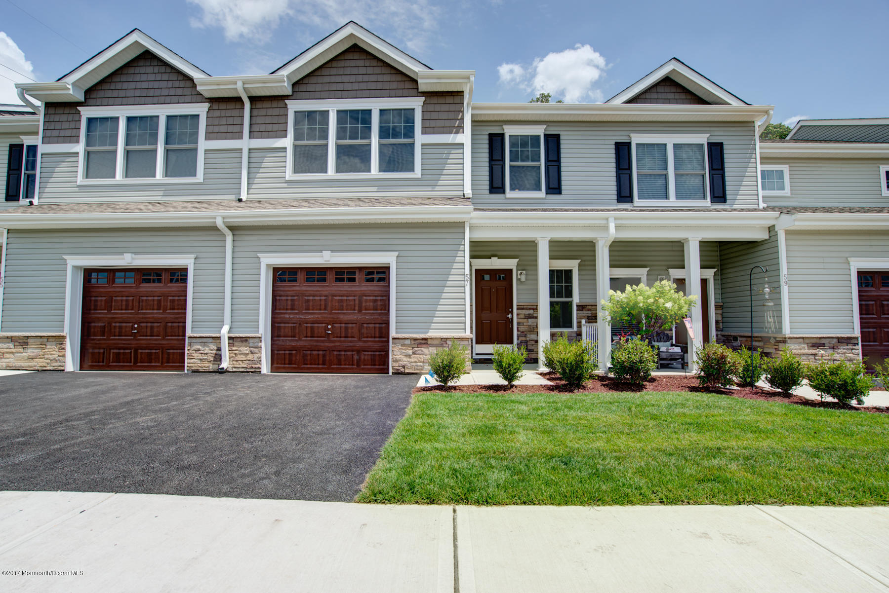 53 Rockingham Way Manchester Township, NJ 08759 - Photo 2 of 17 a front view of a house with a yard and garage