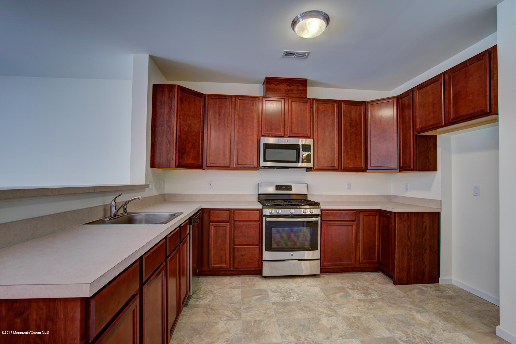 53 Rockingham Way Manchester Township, NJ 08759 - Photo 6 of 17 a kitchen with stainless steel appliances granite countertop a sink stove microwave and refrigerator
