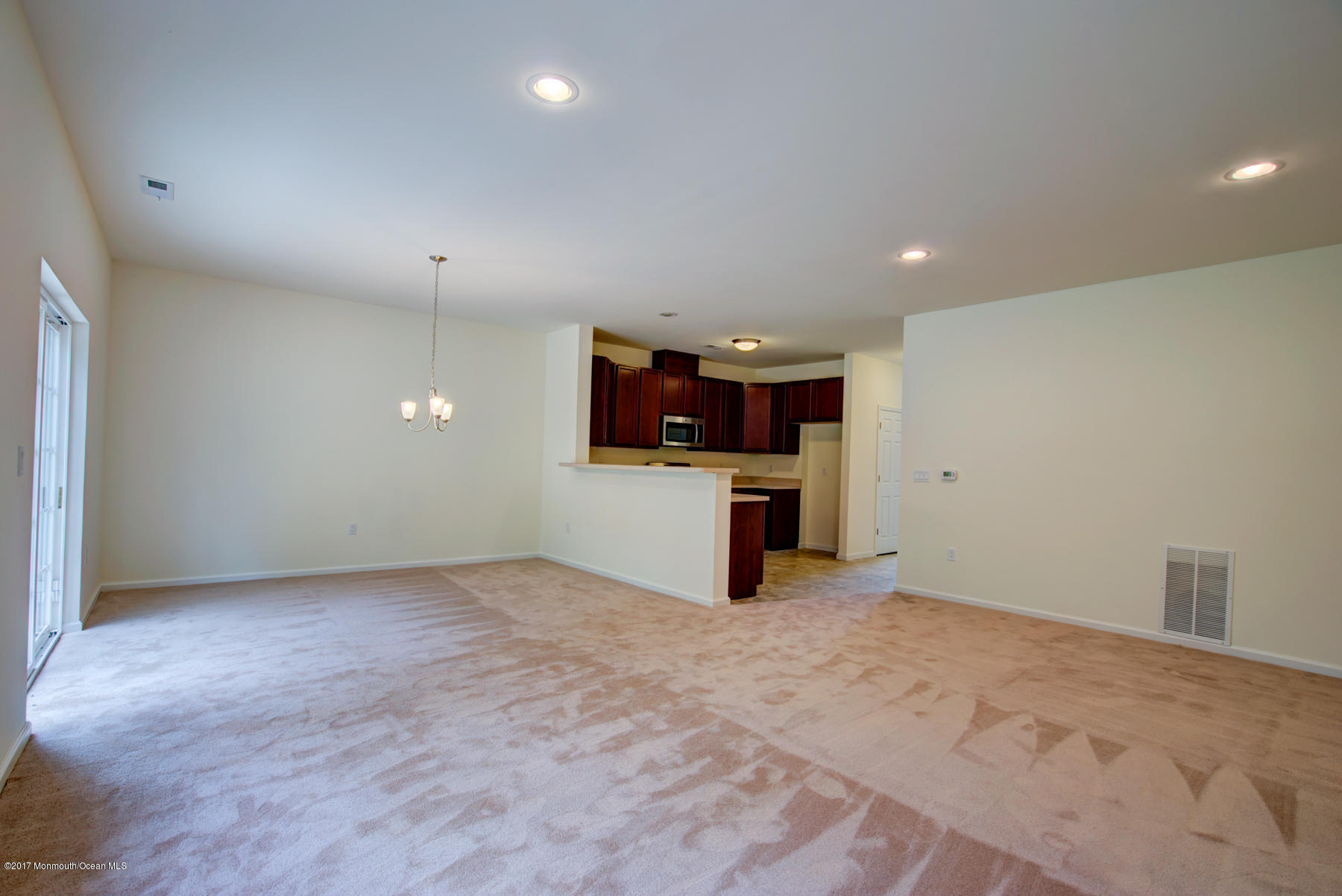 53 Rockingham Way Manchester Township, NJ 08759 - Photo 8 of 17 an empty room with a kitchen and a sink