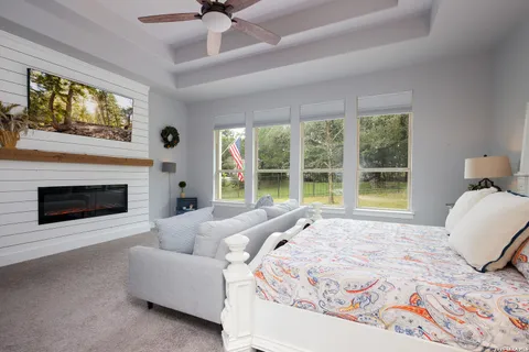 a spacious bedroom with a bed and a large window