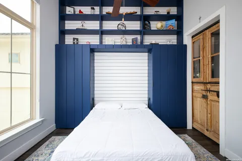 a bedroom with a bed and a window