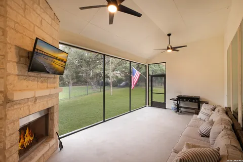 a living room with a fireplace and a floor to ceiling window