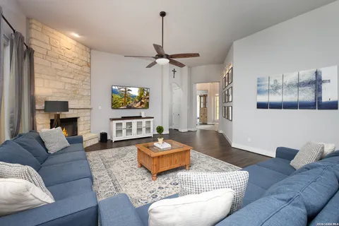 a kitchen with granite countertop a table chairs stainless steel appliances and wooden floor