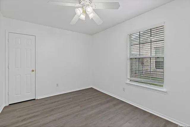 wooden floor in an empty room with a window