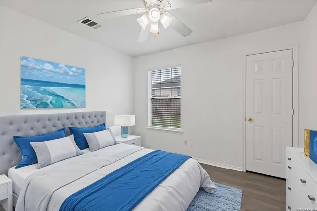 a bedroom with a large bed and a chandelier