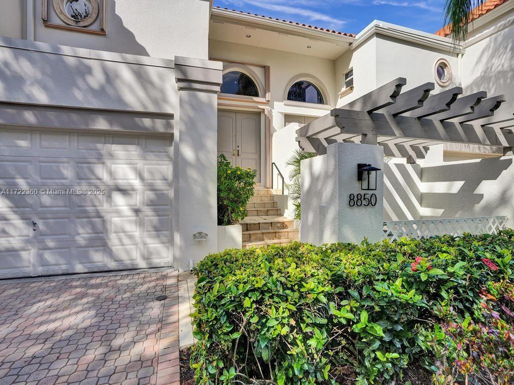 8850 Southwest 67th Court Pinecrest, FL 33156 - Photo 1 of 49 a front view of a house with a yard