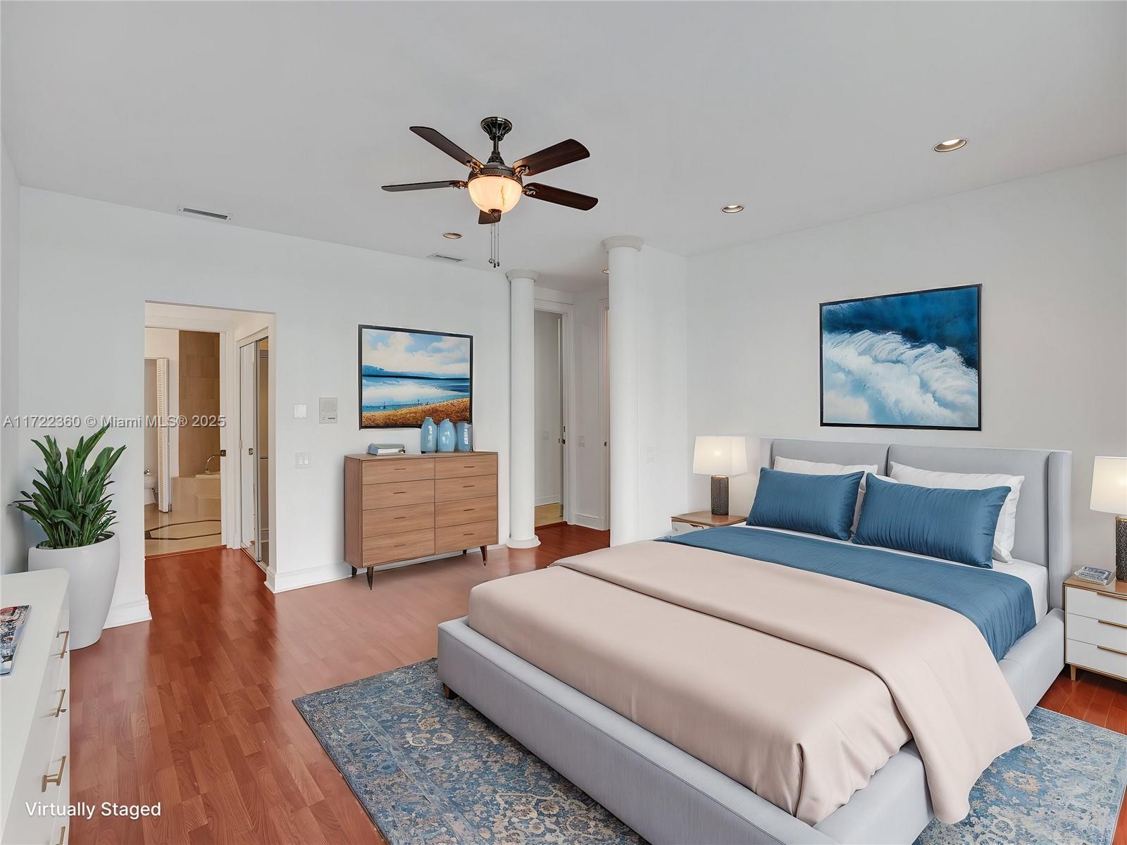 8850 Southwest 67th Court Pinecrest, FL 33156 - Photo 25 of 49 a bedroom with a large bed and a wooden floor