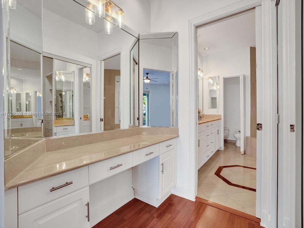 8850 Southwest 67th Court Pinecrest, FL 33156 - Photo 29 of 49 a spacious bathroom with a granite countertop sink and a mirror