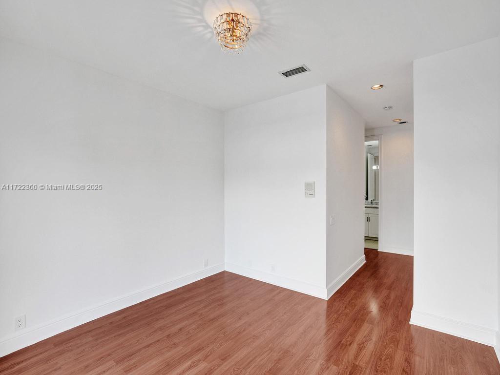 8850 Southwest 67th Court Pinecrest, FL 33156 - Photo 33 of 49 a view of an empty room with wooden floor