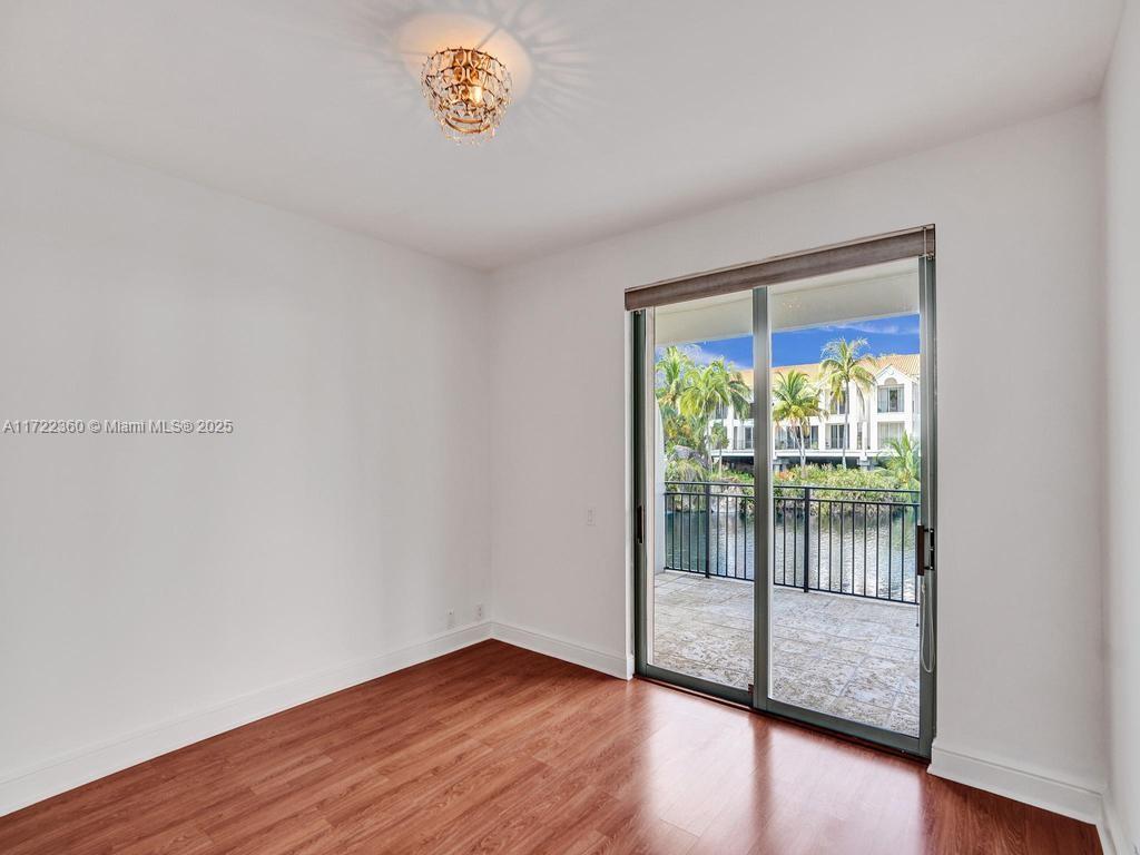 8850 Southwest 67th Court Pinecrest, FL 33156 - Photo 34 of 49 a view of an empty room with wooden floor and a window