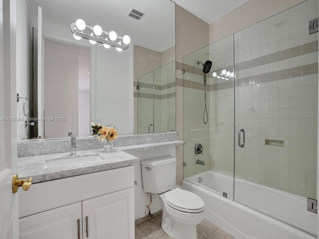 8850 Southwest 67th Court Pinecrest, FL 33156 - Photo 35 of 49 a bathroom with a sink a toilet a large mirror and shower
