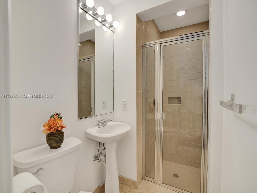 8850 Southwest 67th Court Pinecrest, FL 33156 - Photo 37 of 49 a bathroom with a sink mirror toilet and shower