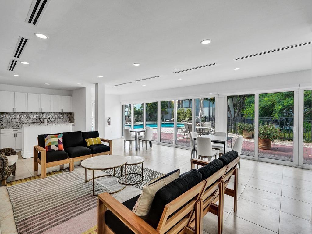 8850 Southwest 67th Court Pinecrest, FL 33156 - Photo 44 of 49 a living room with furniture and a fireplace