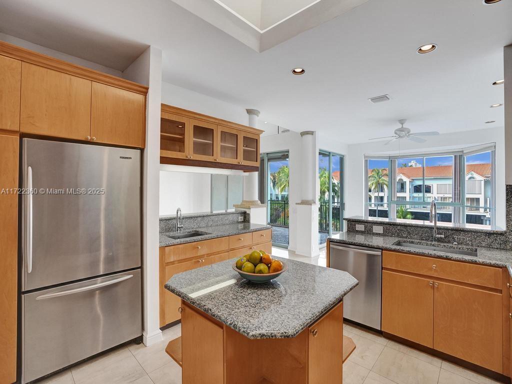 8850 Southwest 67th Court Pinecrest, FL 33156 - Photo 8 of 49 a kitchen with stainless steel appliances granite countertop a sink a refrigerator and a stove