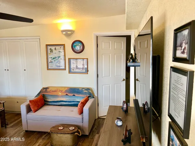 a kitchen with stainless steel appliances granite countertop a dining table chairs and a refrigerator