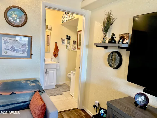 a view of a livingroom with furniture and kitchen view