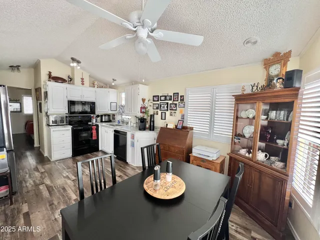 a kitchen with stainless steel appliances granite countertop a refrigerator stove and sink