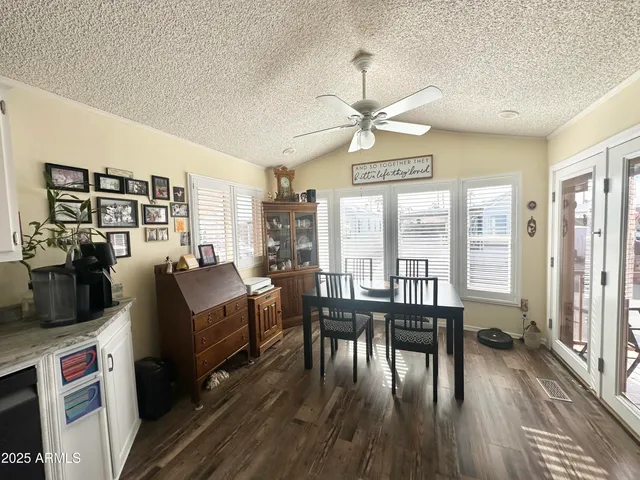 a kitchen with granite countertop a sink and a white cabinets
