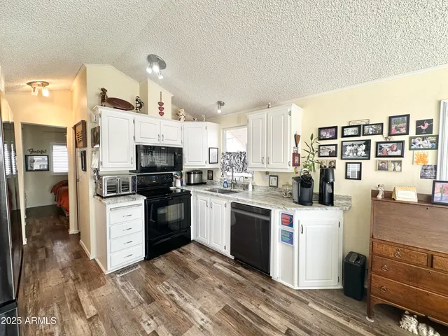 a bathroom with a granite countertop shower a sink and a mirror