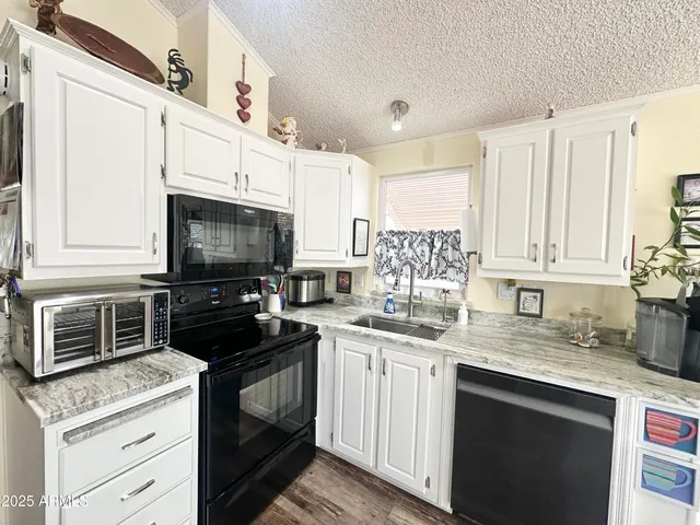 a bathroom with a granite countertop sink a mirror and shower