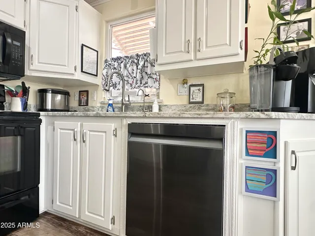 a bathroom with a granite countertop shower sink vanity and mirror