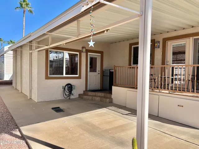 a view of a house and a wooden deck